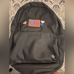 Lululemon Everywhere Black Backpack 22L with heart and American flag patches